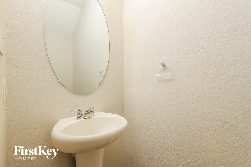 a bathroom with a white sink and a mirror