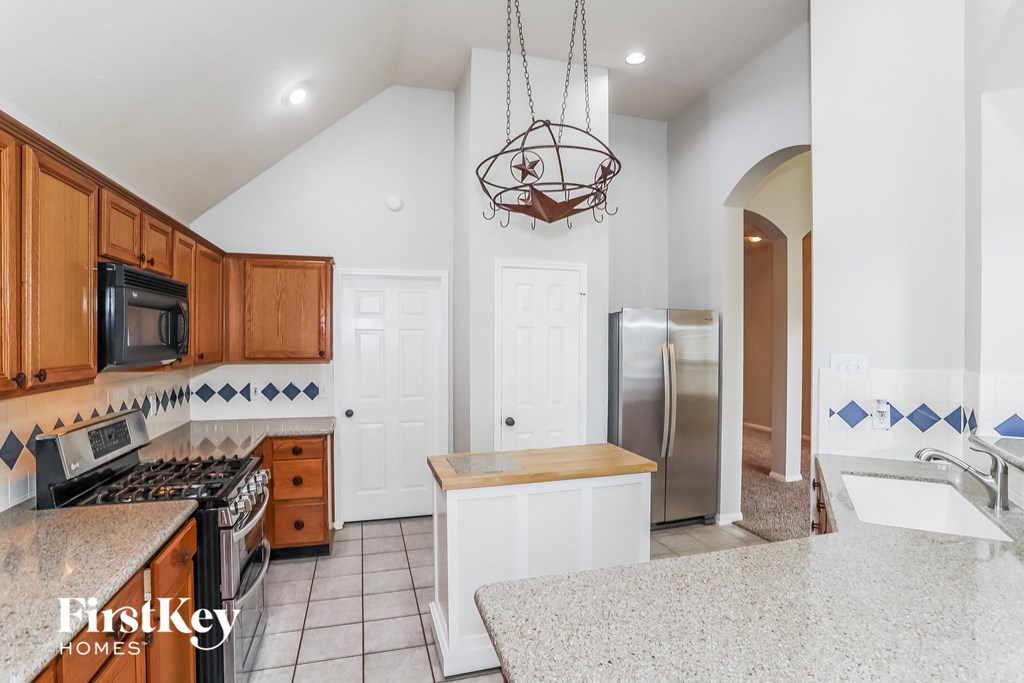 A kitchen with wooden cabinets and a white fridge.