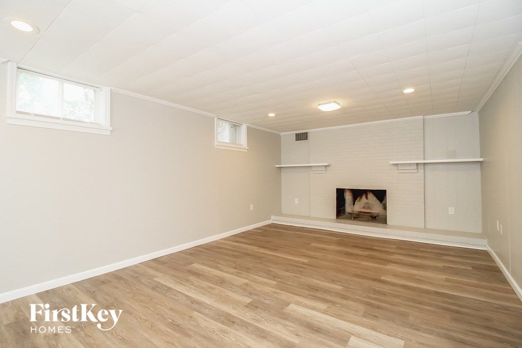 a living room with wood flooring and a fireplace