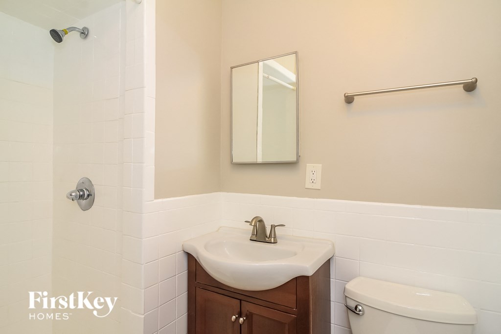 a bathroom with a sink and toilet and a mirror