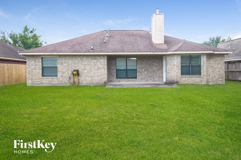 a home with green grass and a yard in front of it