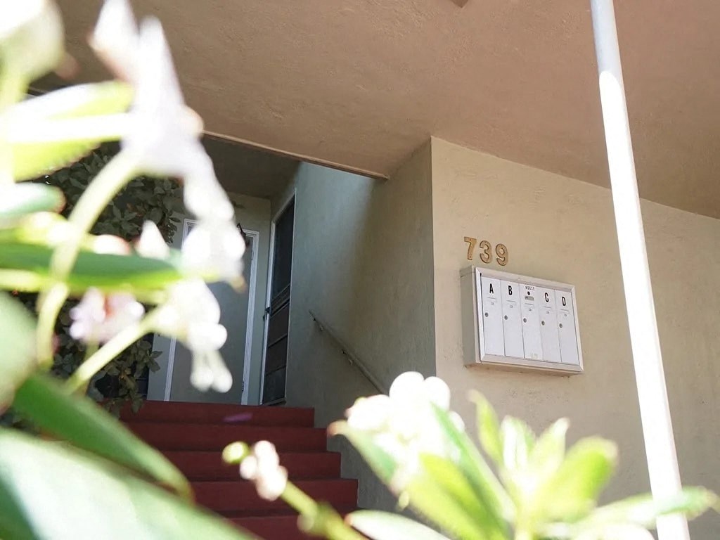 a house with stairs and a lightswitch on the wall