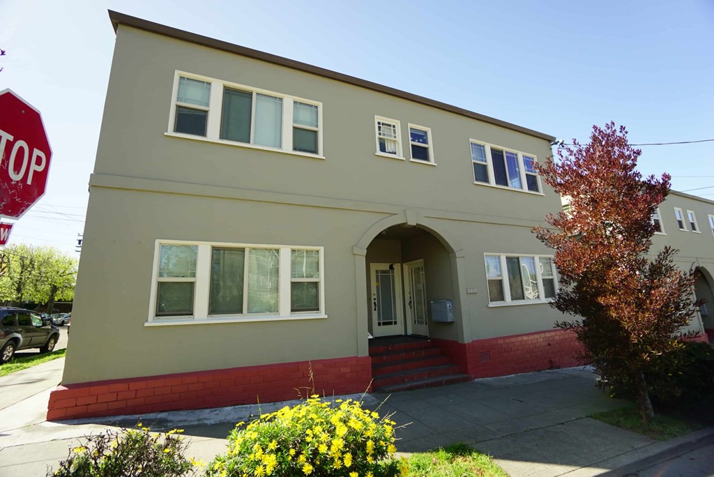 a tan house with a stop sign in front of it