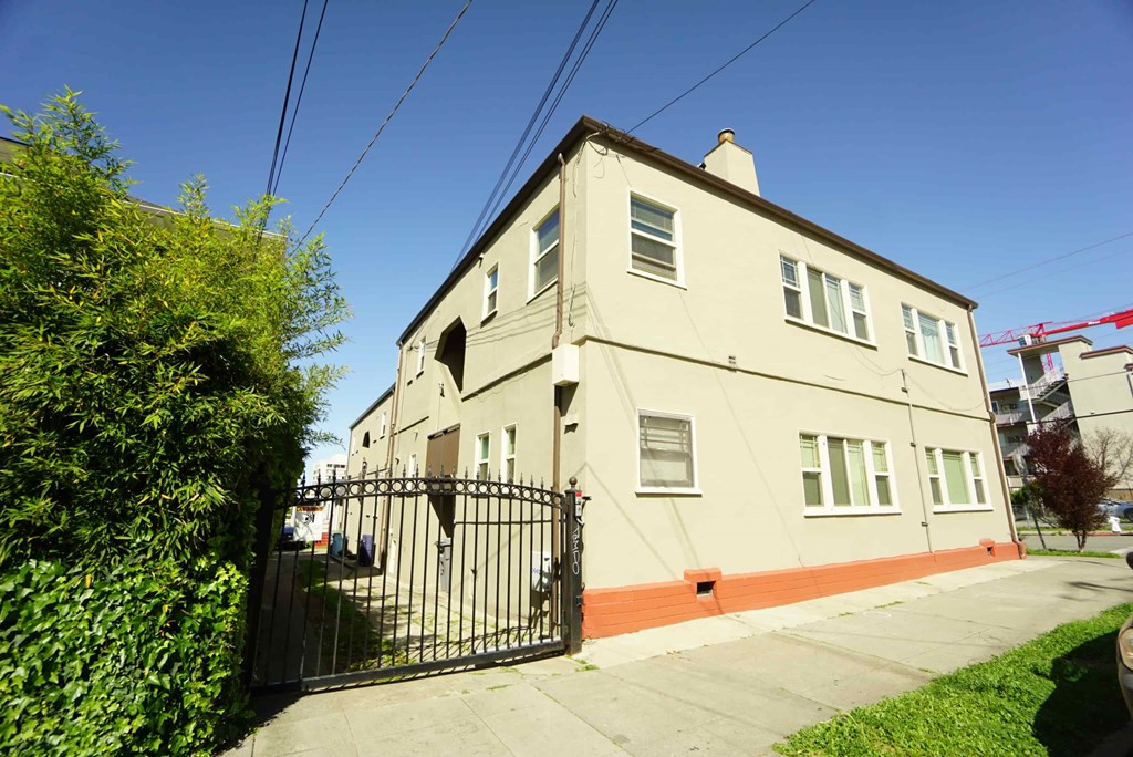 a large white house with a gate in front of it