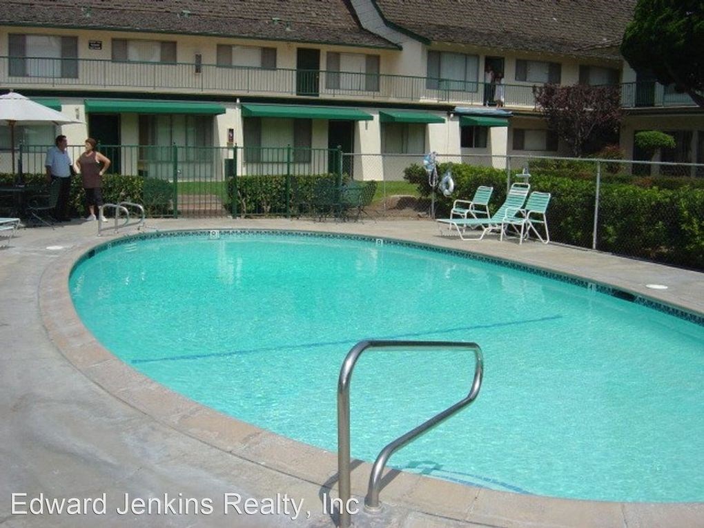 a large swimming pool in front of an apartment building