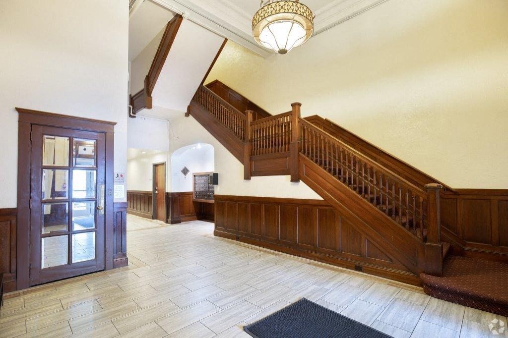 the lobby of a house with a staircase and a door