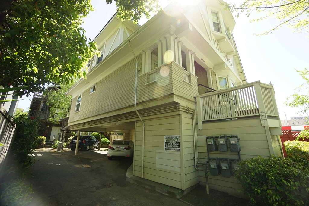 a white house with a car parked in front of it
