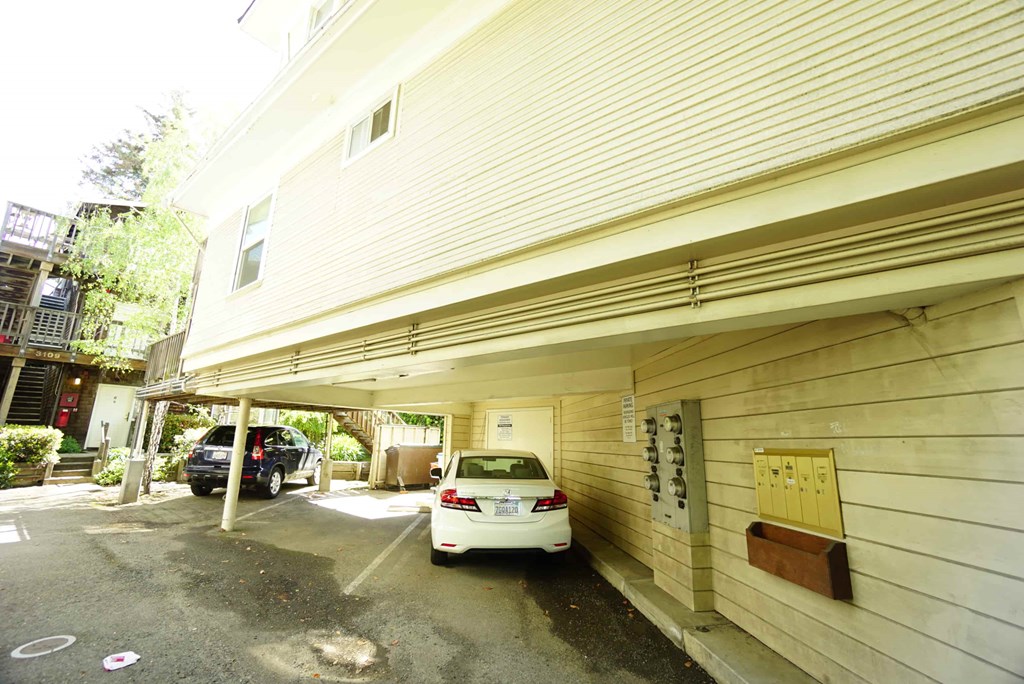 a white car parked outside of a garage