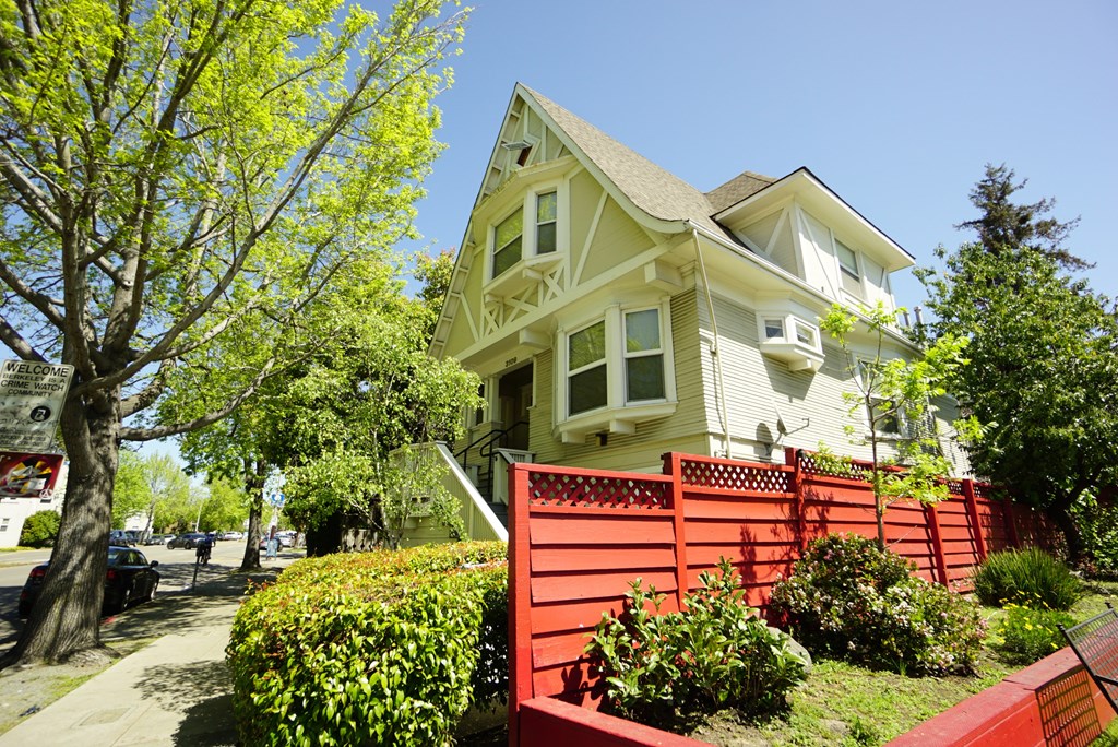a house with a red fence in front of it