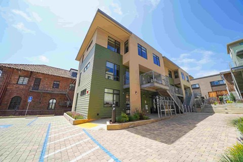 A modern building with a courtyard in front.