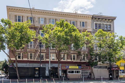 A large building with a yellow sign that says "Hotel" on the front.