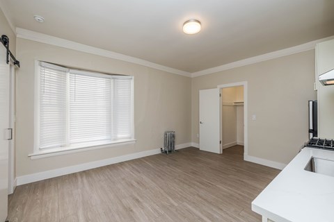 A room with a window, a sink, and a radiator.