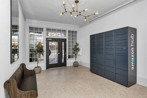A room with a brown chair and a black Amazon Hub locker.