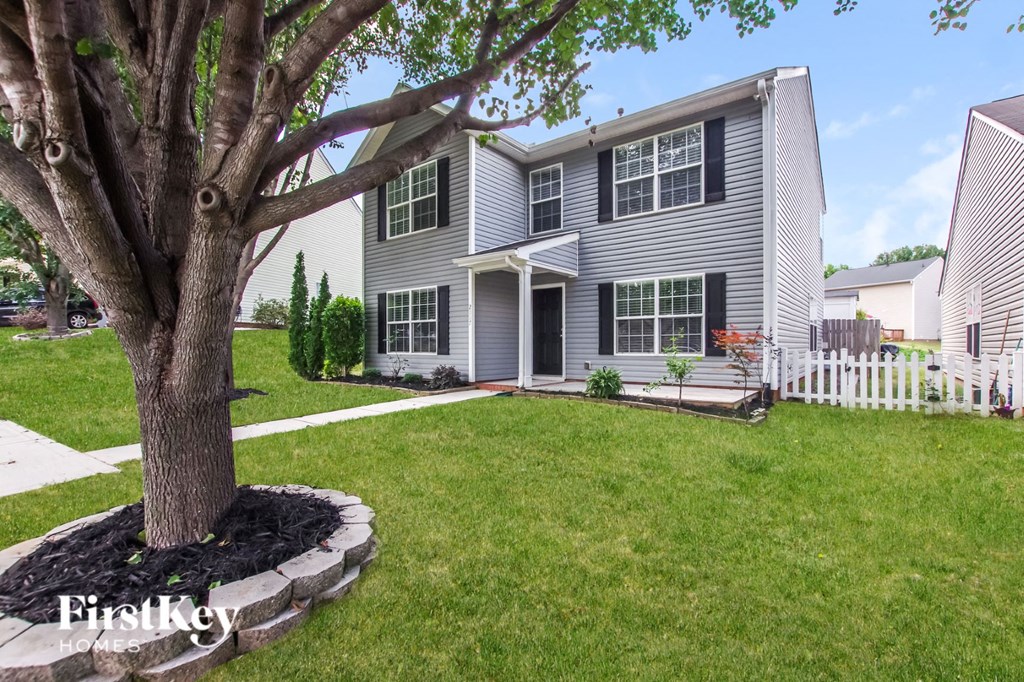 A house with a tree in front of it.