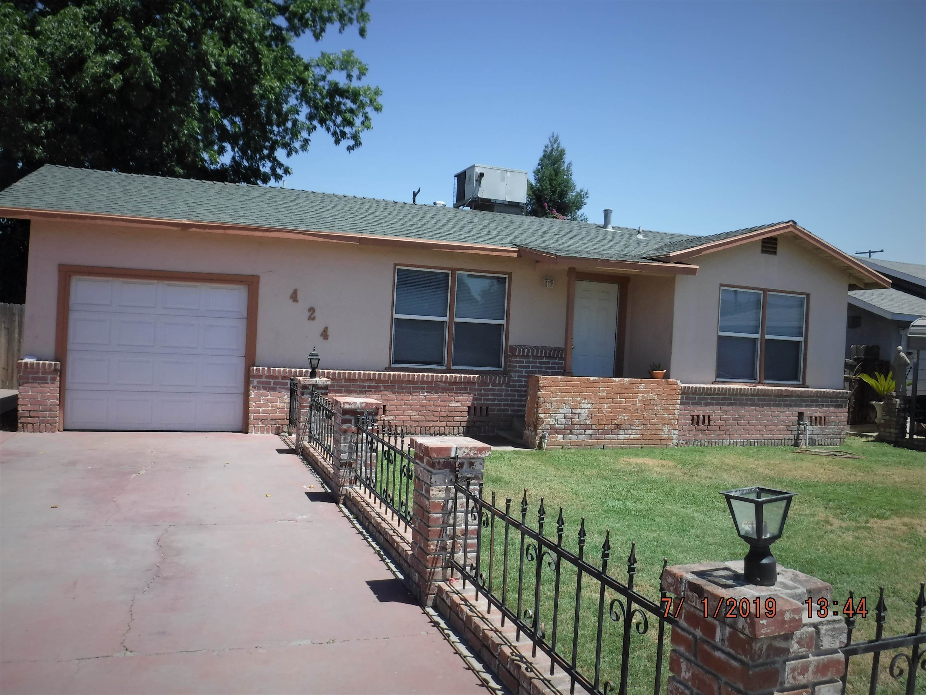 a house with a yard and a white garage door