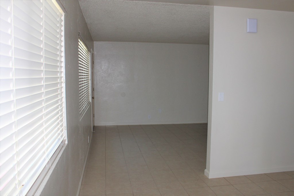 a view of the dining room from the living room of an empty house