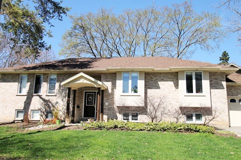 A house with a brown roof and a white front door.