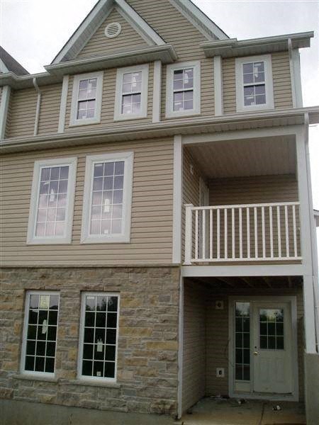A two story house with a balcony on the upper floor.