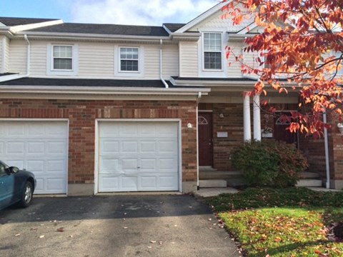 a house with two garage doors in front of it