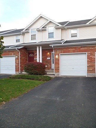 a house with two garage doors and a driveway
