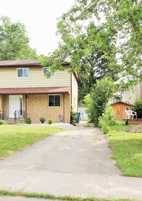 A house with a brown brick exterior and a white door.