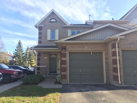 a brick house with a garage and a driveway