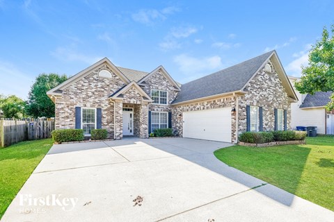 a brick house with a garage and a driveway