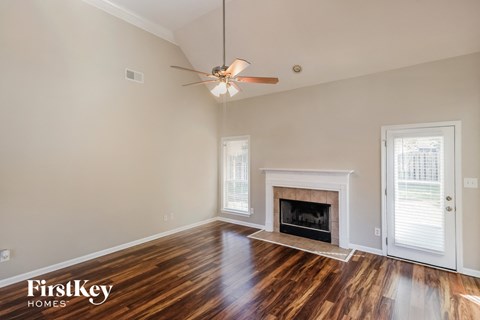 the living room with wood flooring and a fireplace
