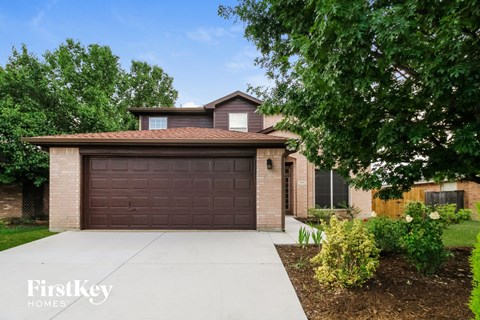 a home with a brown garage door and a driveway