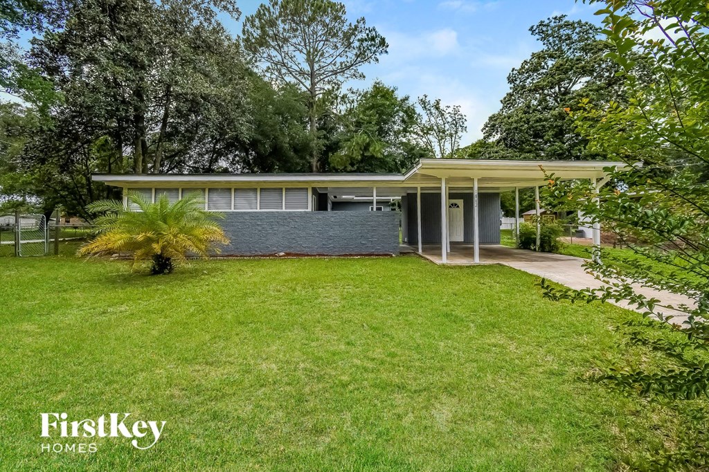 a house with a grass yard and a lawn in front of it