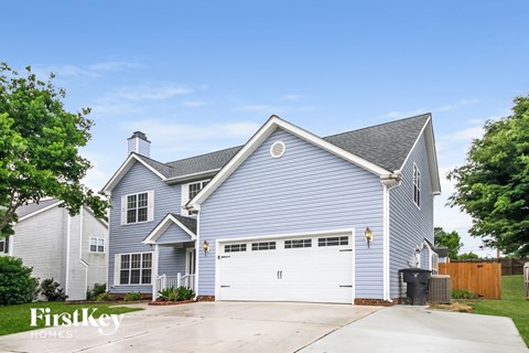 A blue house with a white garage door.