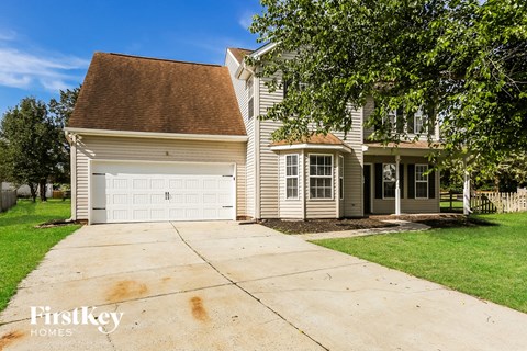 A house with a brown roof and a garage door is for sale.