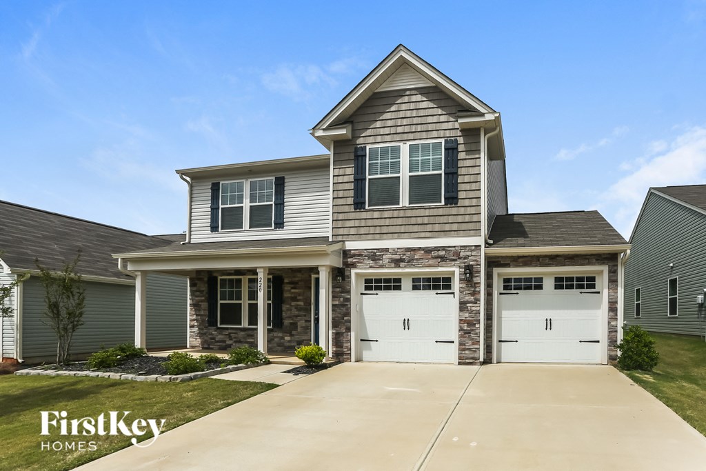 A two-story house with a garage is for sale by FirstKey Homes.