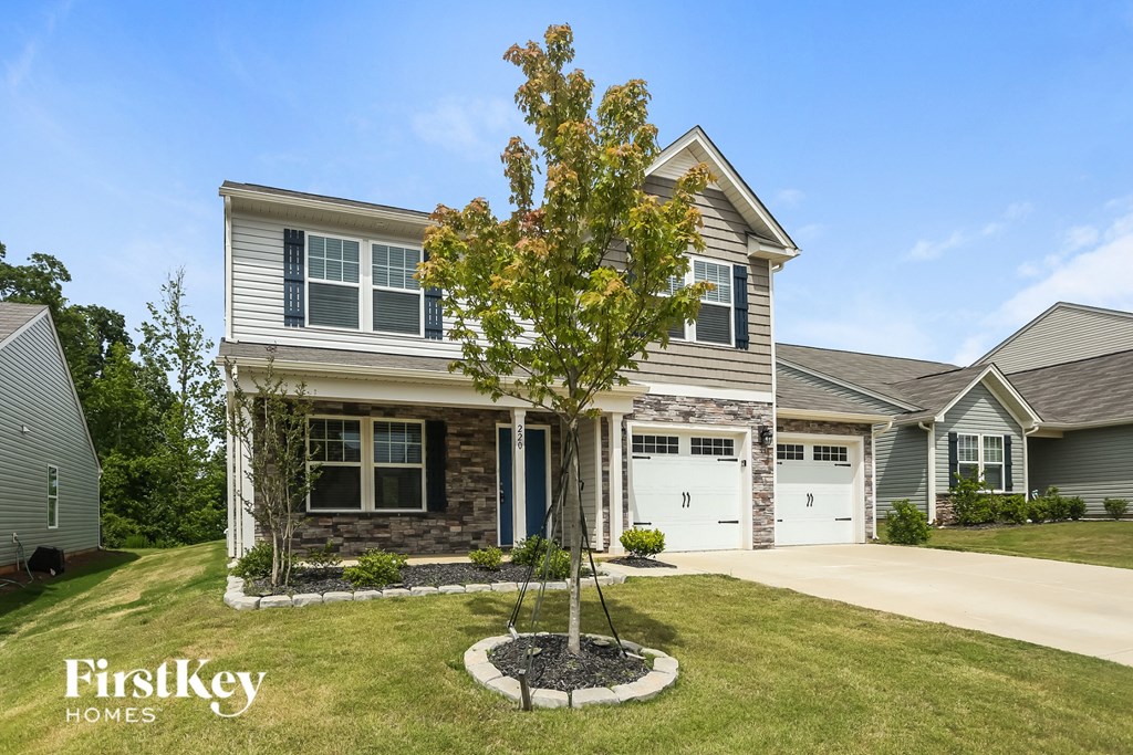 A house with a tree in front of it.
