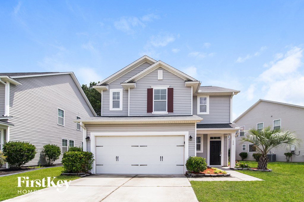 A two-story house with a garage is for sale.