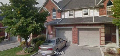a car parked in a driveway in front of a house