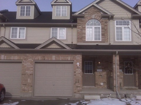 a house with a garage door in front of it