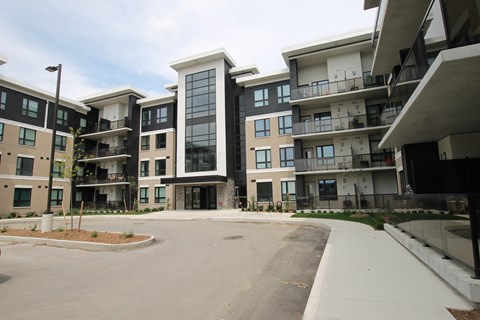 an empty parking lot in front of an apartment building