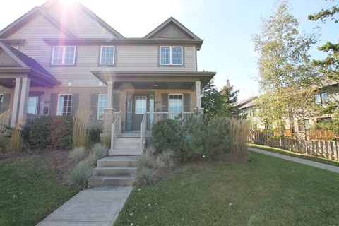 A house with a grey roof and a front porch.
