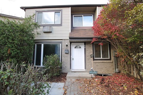 the front of a house with a white door
