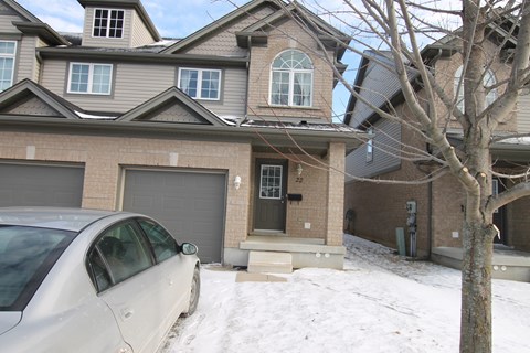 a house with a car parked in the snow