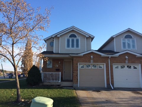 A two-story house with a white garage door.