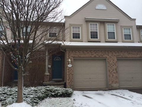 a house with two garage doors in the snow