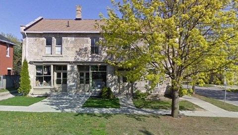 A house with a tree in front of it.