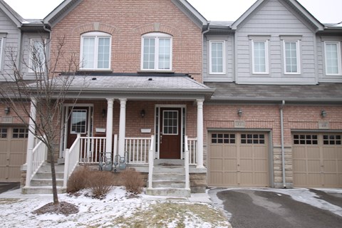 the front of a house with snow on the ground