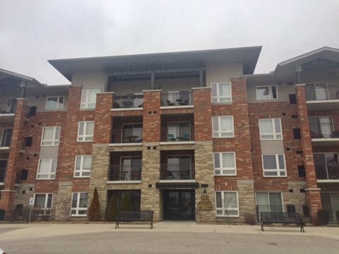 a large brick building with two benches in front of it