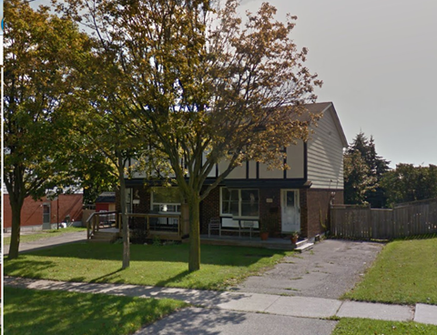 A house with a tree in front of it.