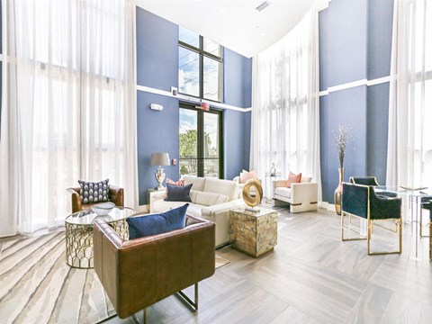 a living room with blue walls and white furniture
