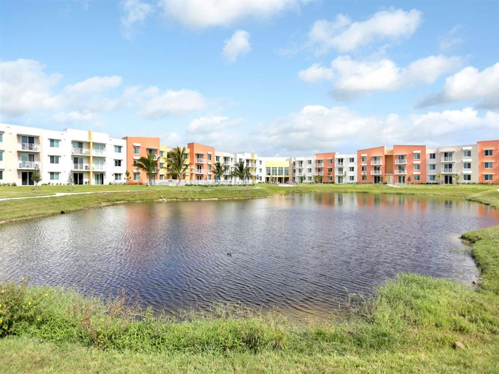 a pond in front of an apartment building