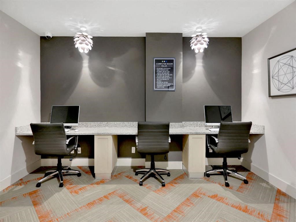 a conference room with four desks and chairs